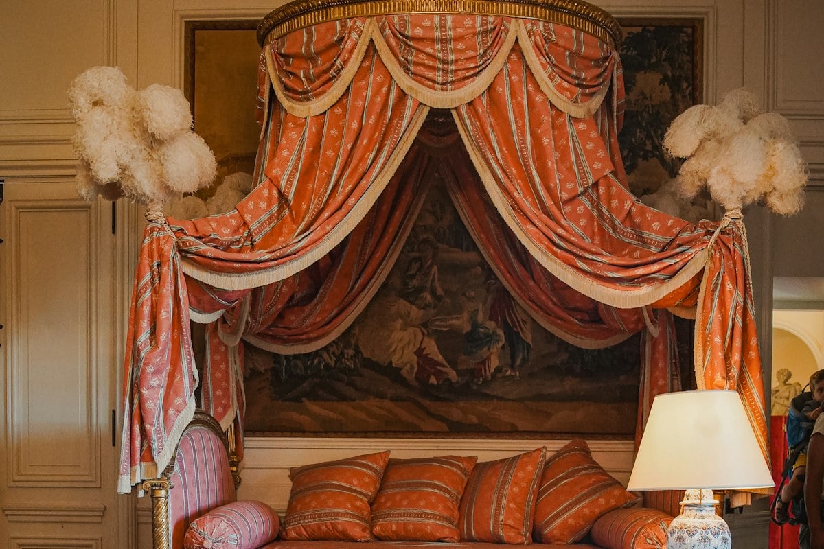 Lit sous un baldaquin de tissu ocre